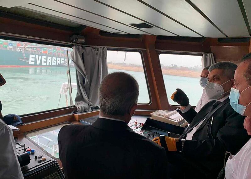 Lt Gen Osama Rabei, head of the Suez Canal Authority, second right, assesses the 'MV Ever Given' from the bridge of a cutter. AP Photo