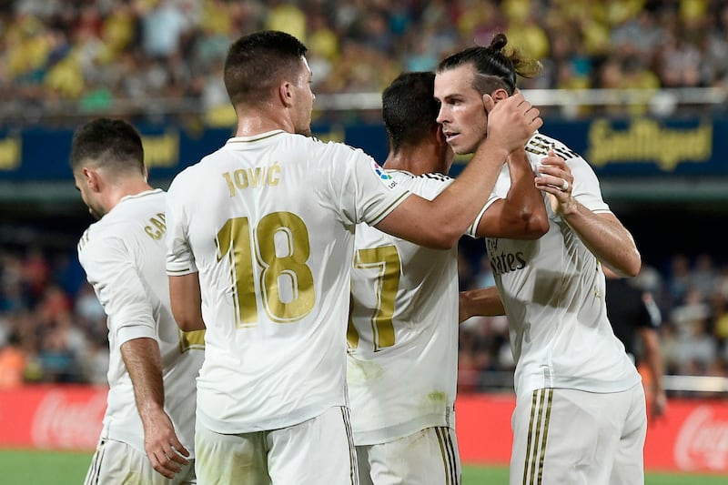 Real Madrid's Welsh forward Gareth Bale (R) celebrates with teammates after scoring during the Spanish league football match Villarreal CF against Real Madrid CF at La Ceramica stadium in Vila-real on September 1, 2019. / AFP / Josep LAGO

