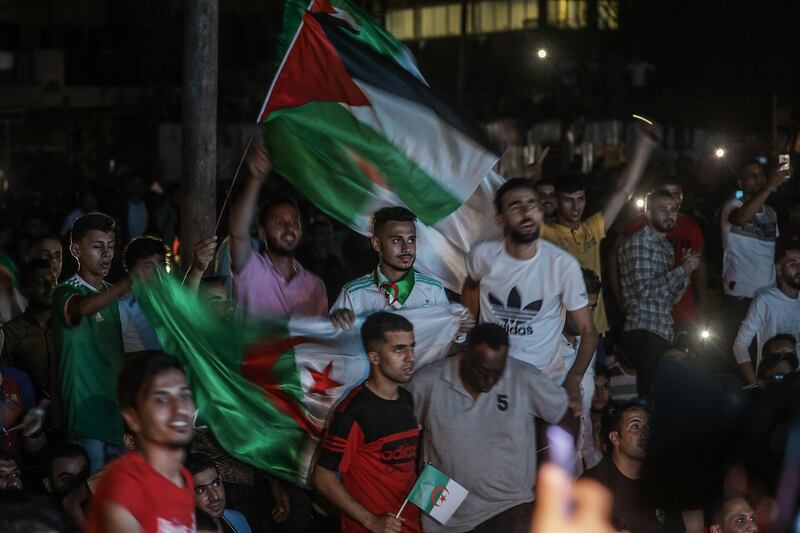 Palestinians supporters of the Algerian team celebrate in Gaza City.  EPA