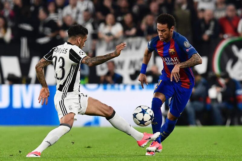 Juventus defender Dani Alves vies with Barcelona's Neymar. Miguel Medina / AFP