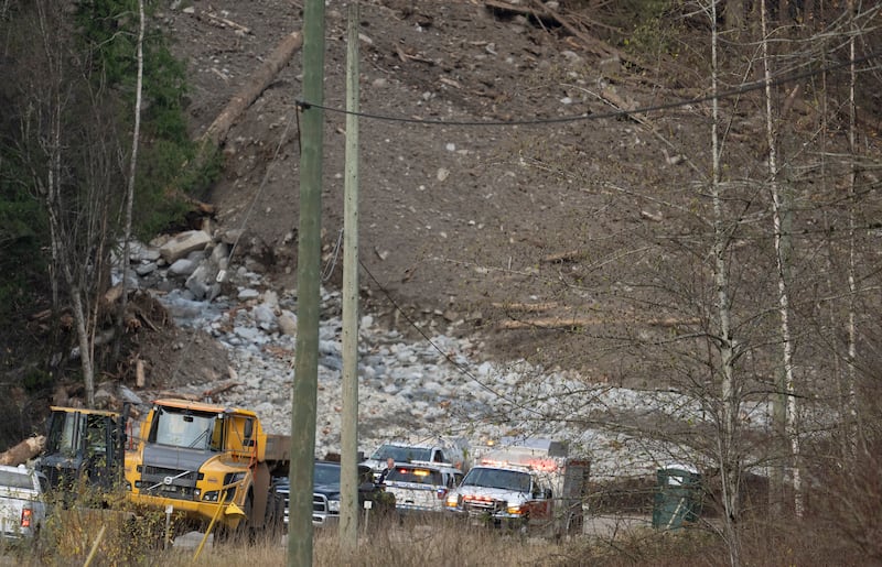 Emergency vehicles and tractors at the base of a mudslide on Highway 7, west of Agassiz, British Columbia.