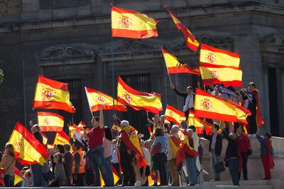 People wave Spanish flags during a mass protest by people angry with Catalonia's declaration of independence, in Madrid, Spain, Saturday, Oct. 28, 2017. Opponents of independence for Catalonia held the rally in the Spanish capital as thousands of people turned out in the Plaza de Colon. The rally comes after one of the country's most tumultuous days in decades. (AP Photo/Paul White)