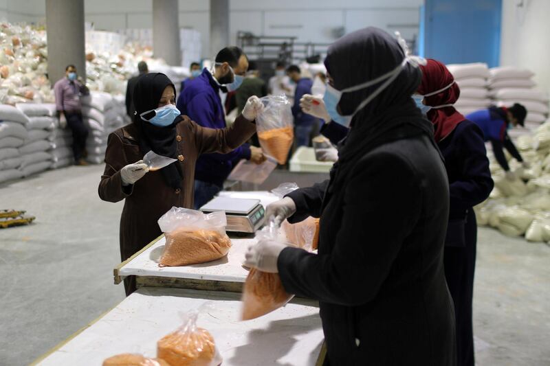Workers pack food supplies to be distributed and delivered by the United Nations Relief and Works Agency to the homes of Palestinian refugees as a precaution against the spread of coronavirus, in the northern Gaza Strip on March 31, 2020. Reuters