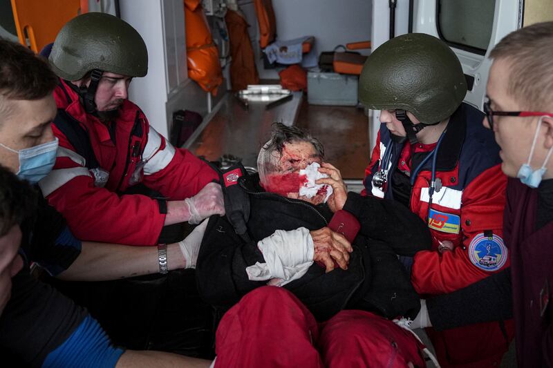 Paramedics tend a civilian wounded by shelling in Mariupol, Ukraine, on March 2. AP