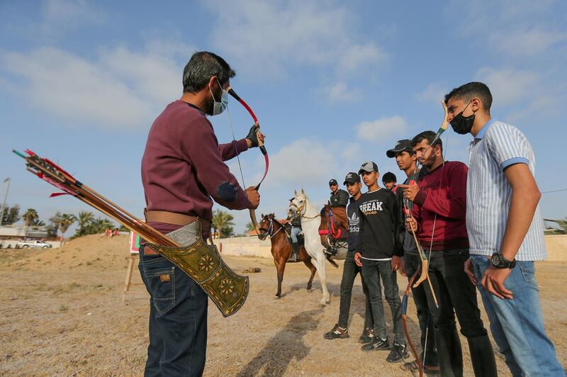 Palestinian coach Mohammad Abu Musaed instructs his team during a horseback archery training session in Zawayda in the central Gaza Strip. Reuters