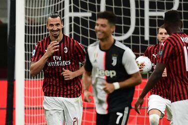 AC Milan's Swedish forward Zlatan Ibrahimovic (L) reacts next to Juventus' Portuguese forward Cristiano Ronaldo (C) after scoring a penalty during the Italian Serie A football match AC Milan vs Juventus played behind closed doors on July 7, 2020 at the San Siro stadium in Milan, as the country eases its lockdown aimed at curbing the spread of the COVID-19 infection, caused by the novel coronavirus. / AFP / Miguel MEDINA