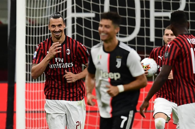 AC Milan's Swedish forward Zlatan Ibrahimovic (L) reacts next to Juventus' Portuguese forward Cristiano Ronaldo (C) after scoring a penalty during the Italian Serie A football match AC Milan vs Juventus played behind closed doors on July 7, 2020 at the San Siro stadium in Milan, as the country eases its lockdown aimed at curbing the spread of the COVID-19 infection, caused by the novel coronavirus.  / AFP / Miguel MEDINA
