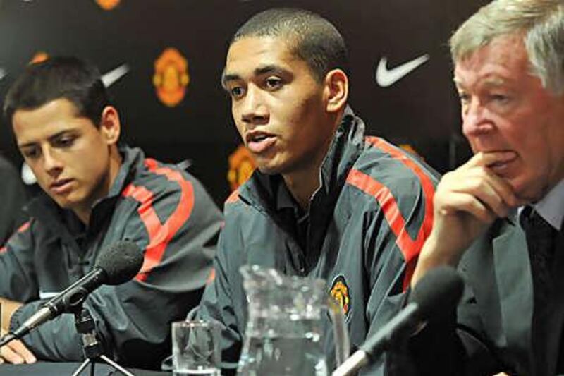 Manchester United manager Sir Alex Ferguson with Javier Hernandez, left, and Chris Smalling.