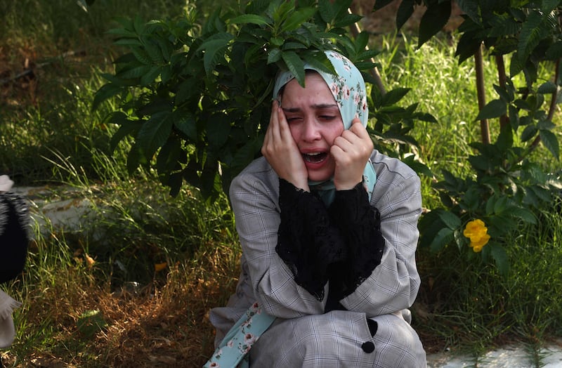 A Palestinian woman sits outside a hospital following the strike. AFP