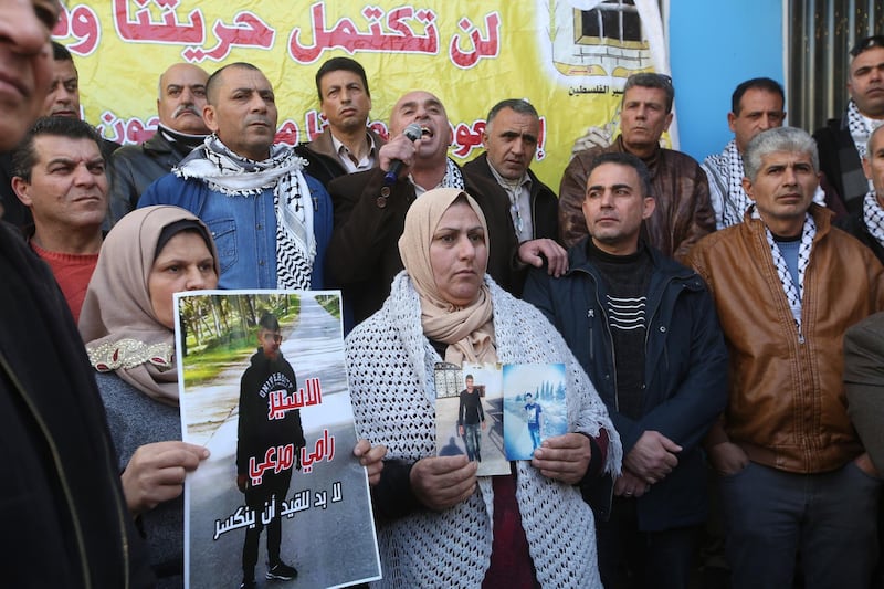 epa07380214 Palestinians hold photos of their relatives held in Israeli jails as they take part in a protest against an Israeli decision to trim funds over prisoner stipends, in the West Bank city of Jenin, 19 February 2019. According to reports, a group of Palestinians gathered to protest against an Israeli decision to deduct 500 million shekels (over 138 million US dollars) from the total sum that was due to be delivered to the Palestinian authority. Israel claims that amount was paid by the Palestinian administration in 2018 in prisoner stipends, thus decided to cut the same amount from the taxes Israel collects on behalf of the Palestinian authority.  EPA/ALAA BADARNEH