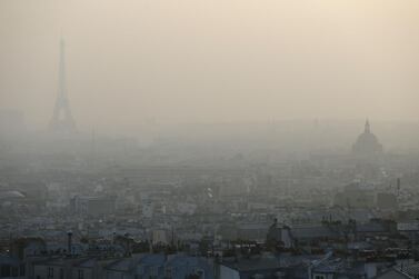 The Eiffel tower and the Paris rooftops through a haze of pollution. The world must slash its emissions of planet-warming greenhouse gases by 7.6 percent every year to 2030 or miss the chance to avert devastating climate change, the United Nations said. AFP