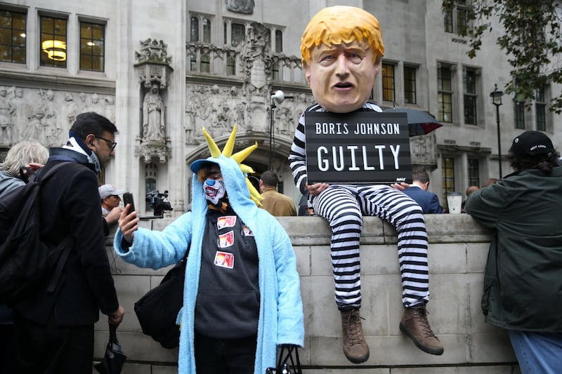 LONDON, ENGLAND - SEPTEMBER 24: A person dressed as Boris Johnson holds a guilty sign as the Supreme Court building rules that the prorogation of Parliament was unlawful on September 24, 2019 in London, England. Britain's top court said that Prime Minster Boris Johnson acted unlawfully when he requested that the Queen prorogue parliament for more than a month, and that lawmakers should reconvene "as soon as possible." (Photo by Hollie Adams/Getty Images)