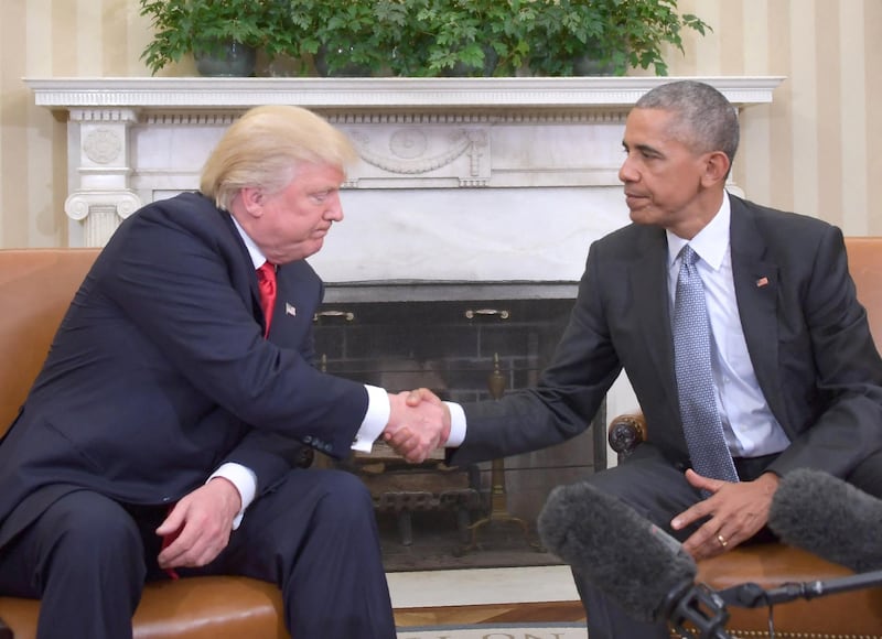 US President Barack Obama shakes hands as he meets with Republican President-elect Donald Trump on transition planning in the Oval Office at the White House on November 10, 2016 in Washington,DC. (Photo by JIM WATSON / AFP)