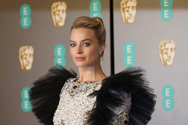 Actress Margot Robbie poses for photographers upon arrival at the Bafta awards in London. AP