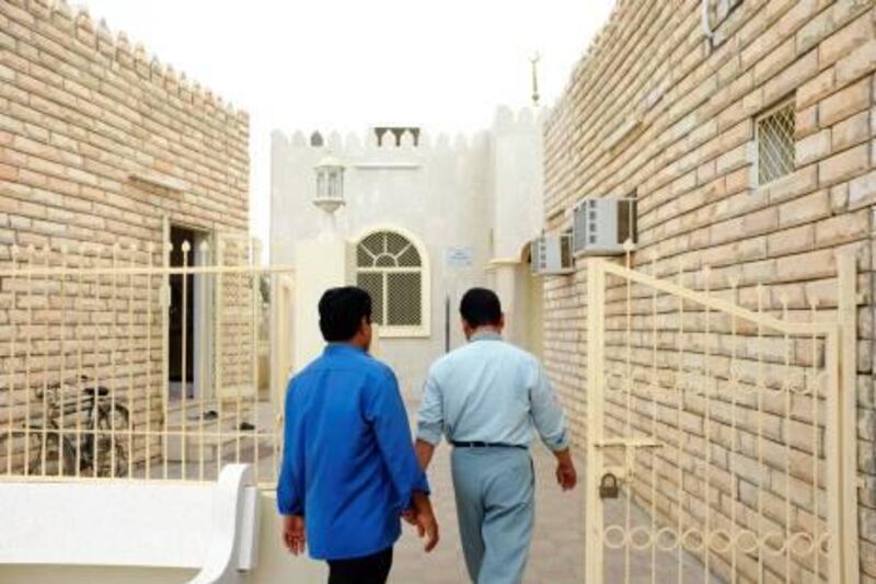 August 18. A worshippers enter the Hateb Bin Amru mosque in Dibba for the midday prayer. August 18, Dibba. United Arab Emirates (Photo: Antonie Robertson/The National)