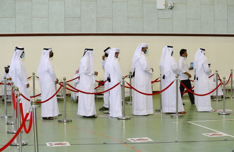 Voters line up at a polling station in Qatar's first legislative elections for two-thirds of the advisory Shura Council. AFP