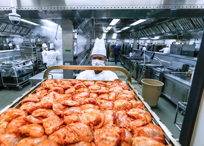 The marinated chickens are put on trays and taken to another kitchen to be roasted. 