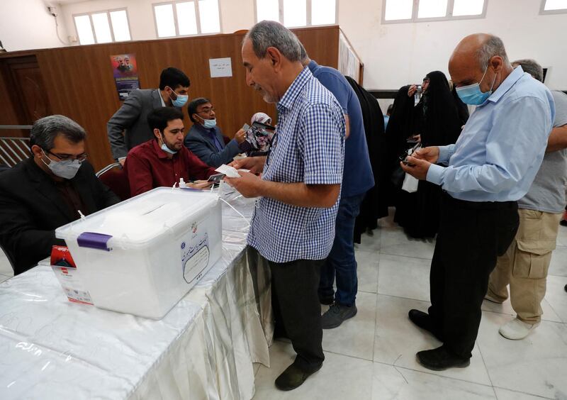 Iranian men register to vote during the presidential election in their country, at a polling station inside the Iranian embassy in the Iraqi capital Baghdad. AFP