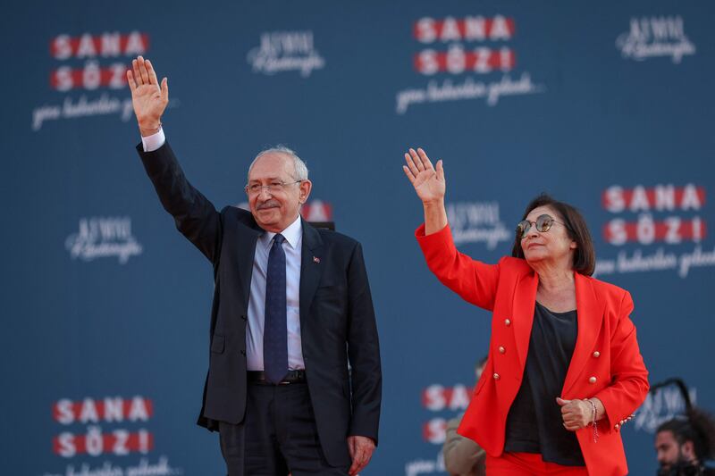 Mr Kilicdaroglu and his wife Selvi wave to supporters. Republican People's Party Press Service / AFP