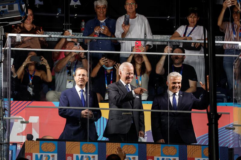 US President Joe Biden, centre, Israel's caretaker Prime Minister Yair Lapid, right, and President Isaac Herzog attend the opening ceremony for the Maccabiah Games in Jerusalem. Reuters