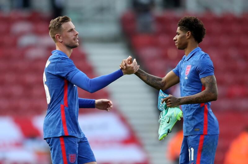 England's Jordan Henderson shakes hands with Marcus Rashford after the match. Reuters