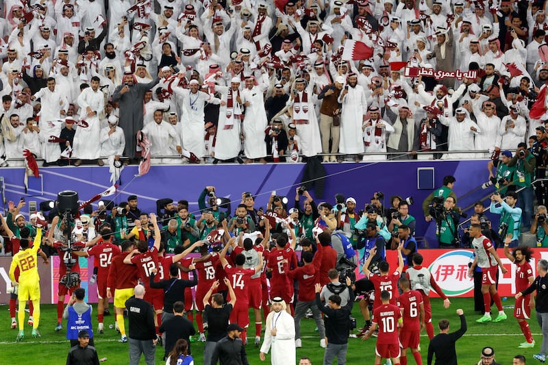 Qatar's players greet their fans at the end of the match. AFP