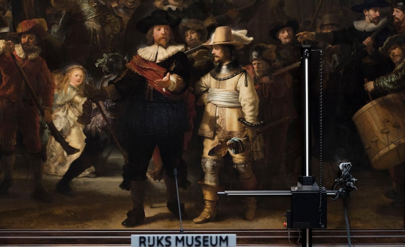 Equipement for analyzing the painting's condition is seen next to Rembrandt's Night Watch, which will be restored next year in the public eye in the Rijksmuseum in Amsterdam, Netherlands, Tuesday, Oct. 16, 2018. (AP Photo/Peter Dejong)