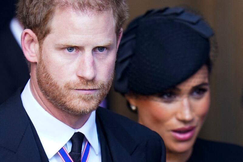 Britain's Prince Harry and his wife Meghan leave after a service for the reception of Queen Elizabeth II's coffin at Westminster Hall, London, on Wednesday. AFP