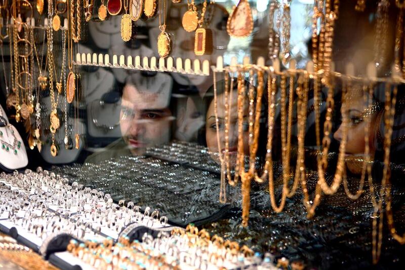 Iranians shop for gold in Tehran. Demand for the precious metal rose 40 per cent in the third quarter. Newsha Tavakolian For The National