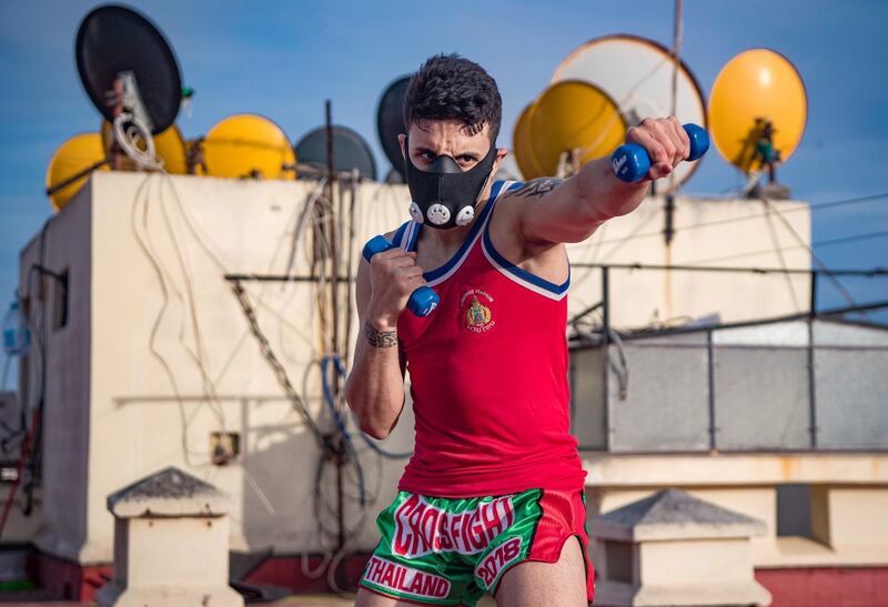 Zakaria Bouamama, a Moroccan professional Muay Thai coach and fighter, trains on the rooftop of a building in Rabat. AFP