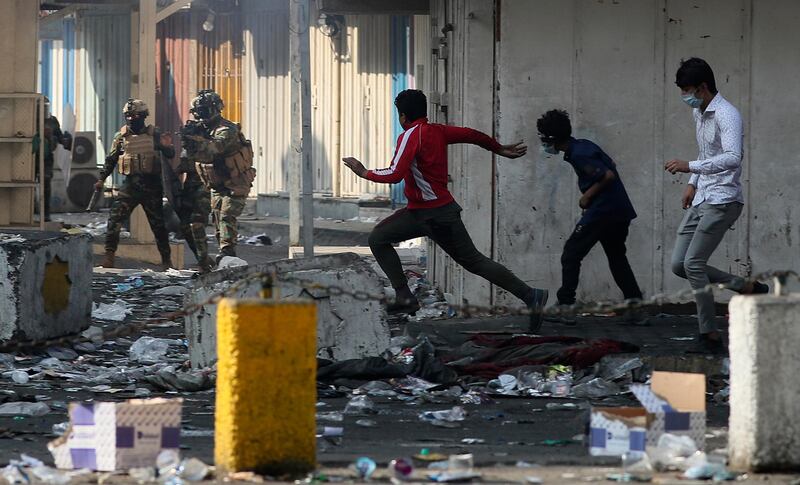 Iraqi security forces try to disperse anti-government protesters in downtown, Baghdad. AP Photo