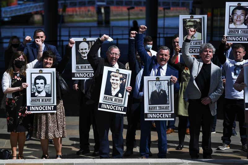 Family members of the victims gesture as they pose for a picture following a news conference after listening to the findings of the report on the fatal shootings of 10 people in the Ballymurphy area of Belfast in 1971 that involved the British Army, in Ballymurphy, Belfast, Northern Ireland, May 11, 2021. REUTERS/Clodagh Kilcoyn