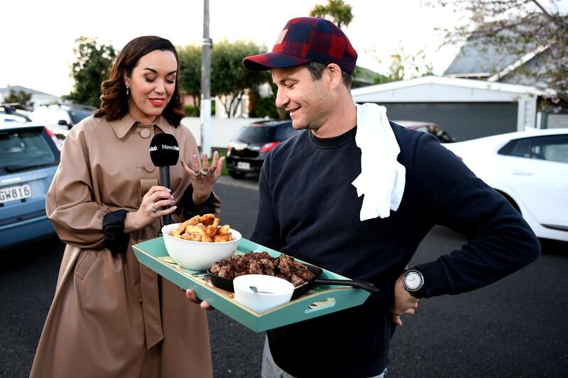 New Zealand Labour Party leader Jacinda Ardern's partner Clarke Gayford delivers home cooked food to the media waiting outside their house. Getty Images