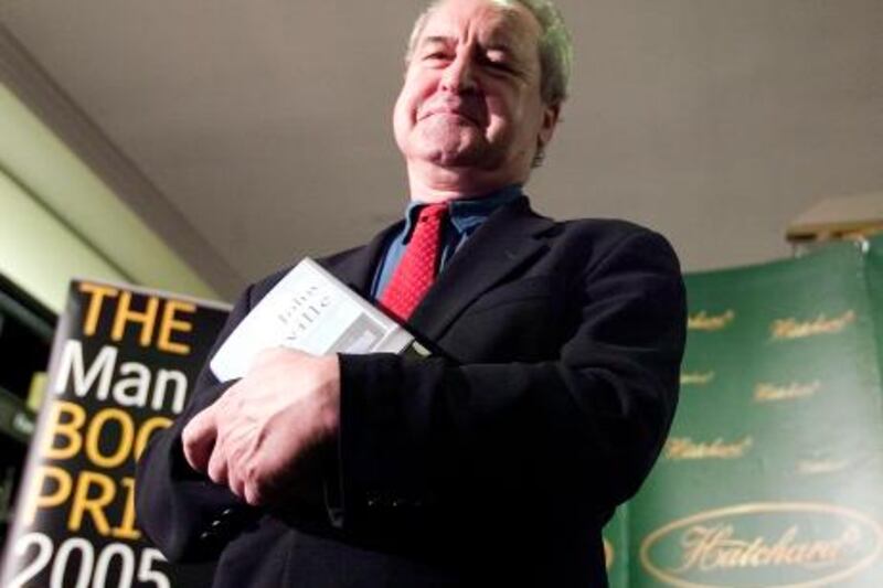 John Banville poses with her book "The Sea"  for pictures for the Man Booker Prize for Fiction nominations at Hatchards book store, in London, 10 October 2005.  The six books shortlisted to win the prestigious Booker Prize were announced Thursday, with Julian Barnes, Kazuo Ishiguro, Ali Smith, Sebastian Barry and Zadie Smith also making the cut. The prize is awarded every October for the best work of fiction by a British, Irish or Commonwealth author.  AFP PHOTO LEON NEAL