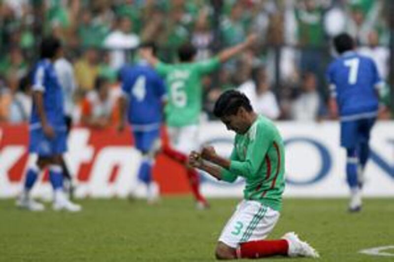 Mexico's Carlos Salcido celebrates after his teammate Cuauhtemoc Blanco scores against El Salvador.