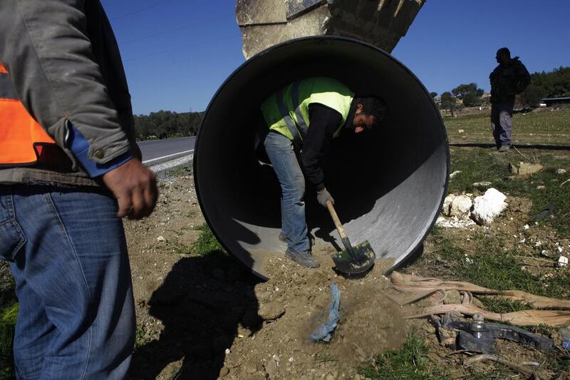 Workers lay a pipeline along the side of a road in Turkish northern Cyprus, between Panagra village and divided capital Nicosia on February 5. The pipeline is part of a project now under construction to send water from the Turkish mainland to the breakaway north of ethnically split Cyprus. Petros Karadjias / AP