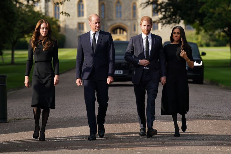 The princes and their wives on the Long Walk at Windsor Castle, heading to meet mourners who had gathered and left tributes to Queen Elizabeth. Getty Images