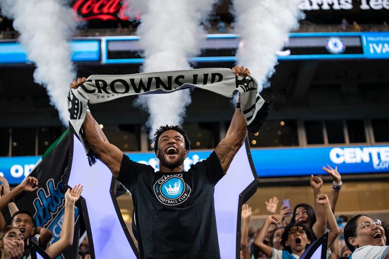 Carolina Panthers safety Jeremy Chinn cheers with fans before the match between Charlotte and Chelsea. AP