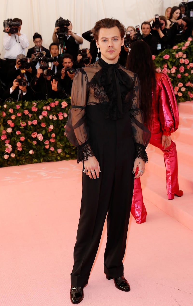 Harry Styles wore high waisted black trousers and a sheer black shirt, with cravat to the Met Gala. Reuters