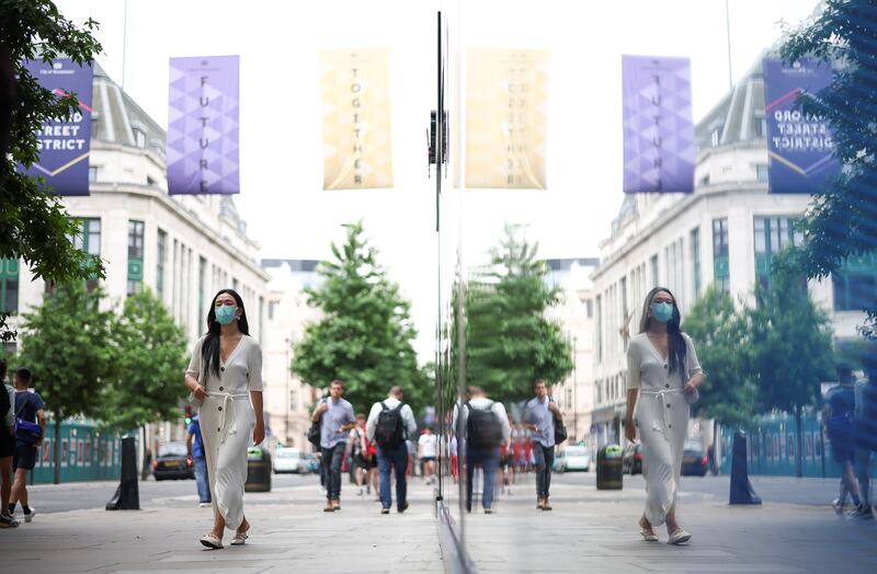 People walk along Oxford Street in central London. England lifted most Covid-19 restrictions on July 19.