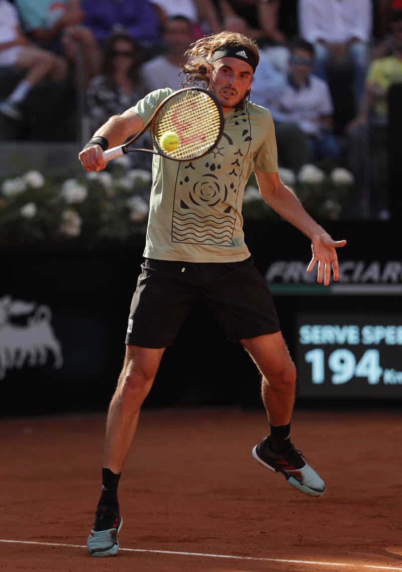 Stefanos Tsitsipas plays a backhand against Novak Djokovic. Getty