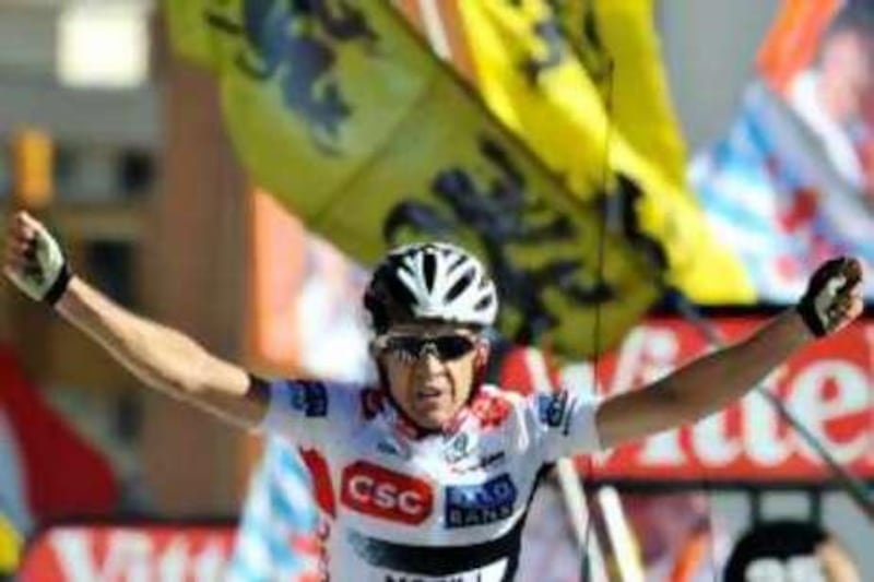 Spanish co-team leader Carlos Sastre (CSC/Den) jubilates on the finish line, on July 23, 2008, at the end of the 210,5 km seventeenth stage of the 2008 Tour de France cycling race run between Embrun and L'Alpe d'Huez. Sastre took the yellow jersey. AFP PHOTO PATRICK HERTZOG *** Local Caption ***  938662-01-08.jpg