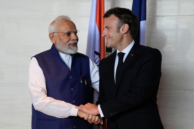 Mr Modi and Mr Macron. AP