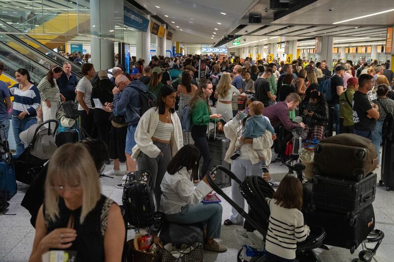 People wait near packed check-in desks at Gatwick Airport. Getty Images