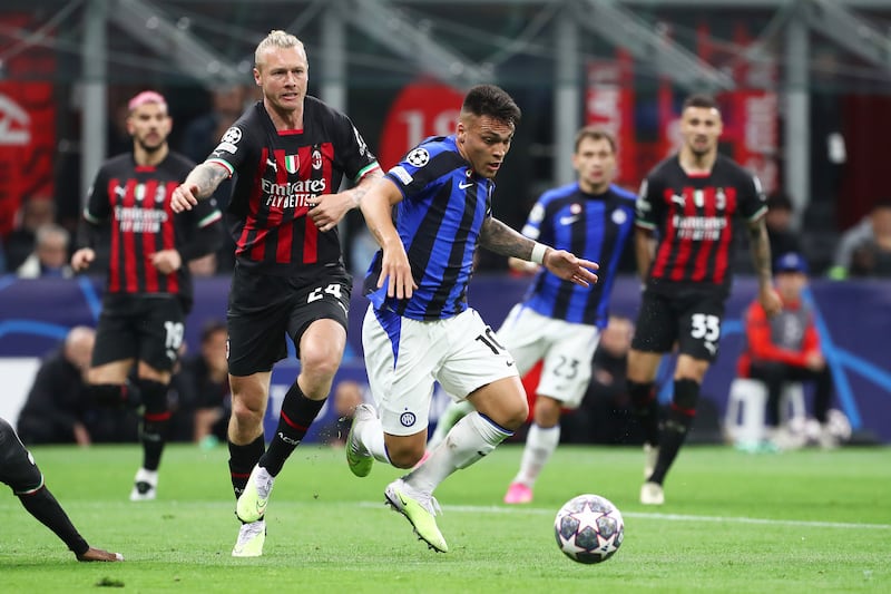 Lautaro Martinez of Inter goes down in the box after a tackle by Simon Kjaer of AC Milan. The referee initially awarded a penalty but later overturned the decision after a VAR check. Getty 