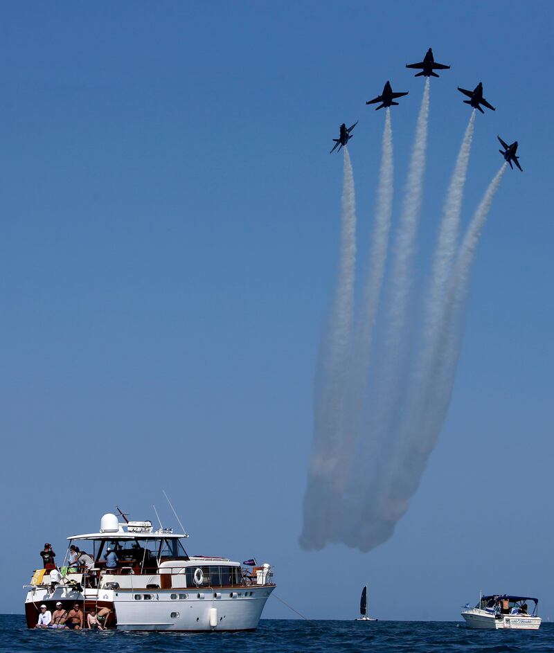 The US Navy Blue Angels perform as they fly over Lake Michigan along downtown Chicago during the Chicago Air and Water show. Kiichiro Sato / AP Photo