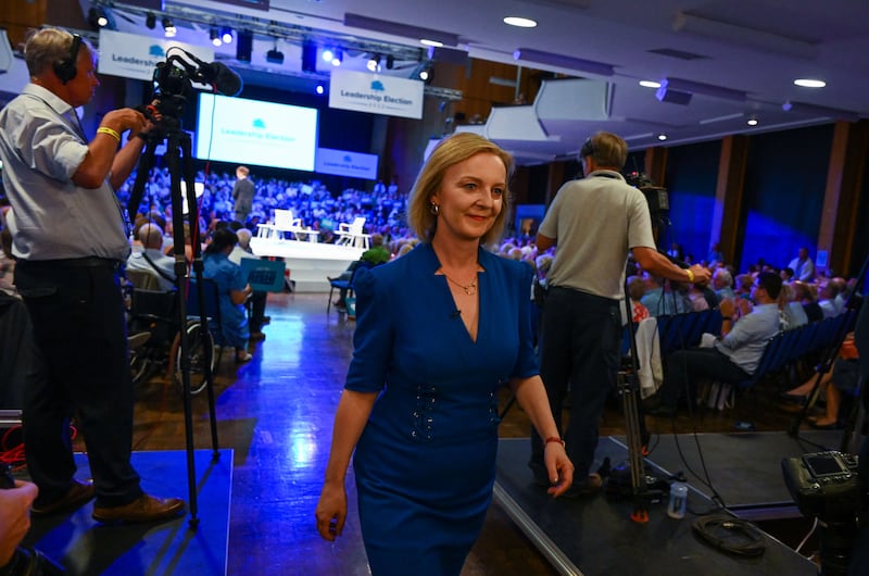 Ms Truss leaves the hall in Exeter, south-west England, after her speech to a Conservative Party membership hustings. Getty