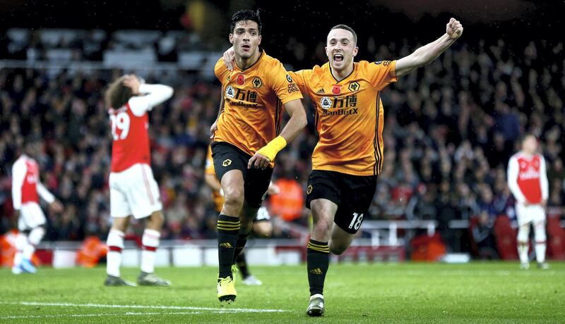 LONDON, ENGLAND - NOVEMBER 02:  Raul Jimenez of Wolverhampton Wanderers celebrates with teammate Diogo Jota after scoring his team's first goal during the Premier League match between Arsenal FC and Wolverhampton Wanderers at Emirates Stadium on November 02, 2019 in London, United Kingdom. (Photo by Jordan Mansfield/Getty Images)