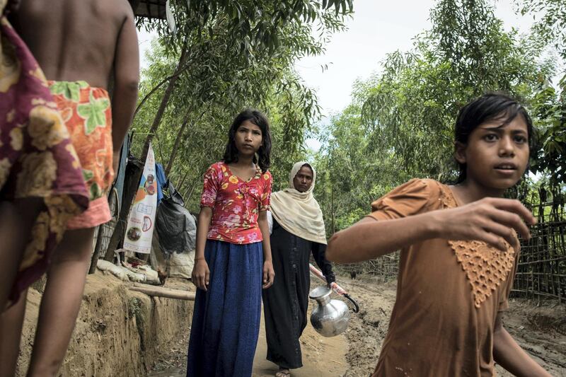 Rohingya women walk on a muddy path in the refugee camp near Cox's Bazar, Bangladesh on August 14 2018. Campbell MacDiarmid for The National