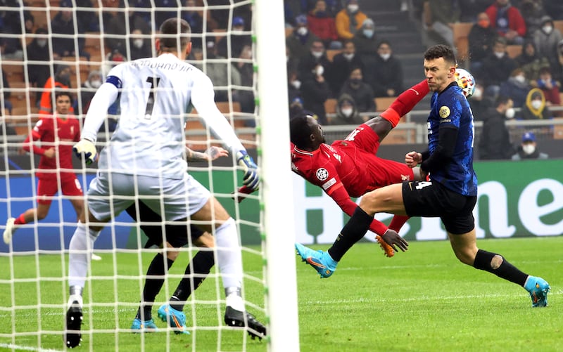 Inter's Ivan Perisic tries a block as Liverpool's Sadio attempts an overhead kick. EPA